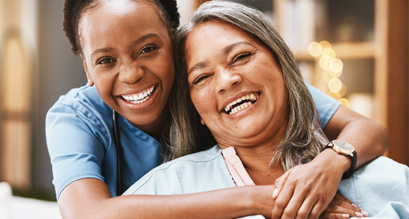 two smiling women embracing with joy in a caring environment showcasing happiness and connection in healthcare relationships five moments of joy five smiles