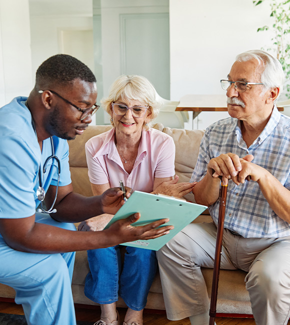 healthcare professional discussing care plan with elderly couple in a comfortable living room setting seniors wellness six important aspects of health